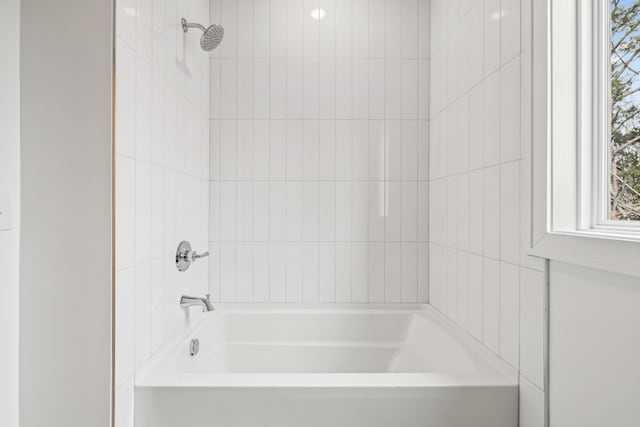 bathroom with bathing tub / shower combination