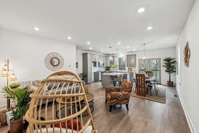 dining room with baseboards, wood finished floors, and recessed lighting