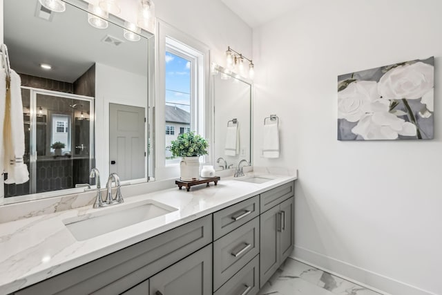 full bathroom featuring marble finish floor, baseboards, visible vents, and a sink