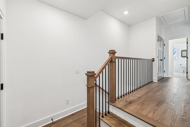 stairway with recessed lighting, baseboards, attic access, and wood finished floors
