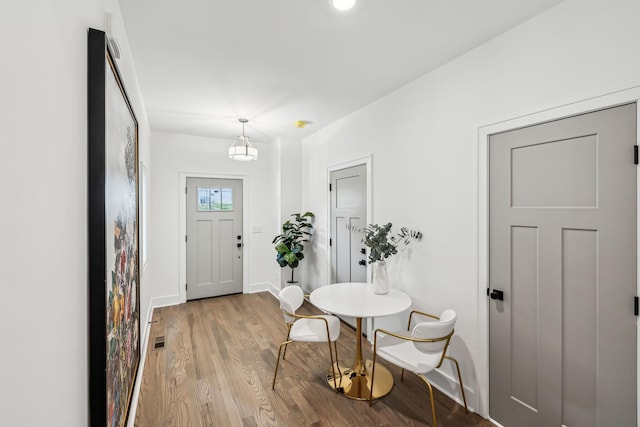 entrance foyer with baseboards, light wood-type flooring, and visible vents