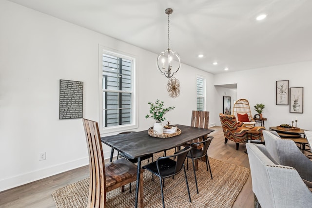 dining room featuring baseboards, light wood-style floors, and recessed lighting