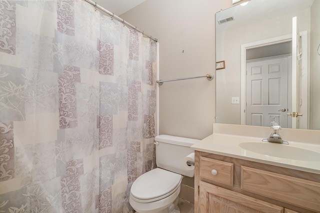 bathroom featuring visible vents, curtained shower, toilet, and vanity