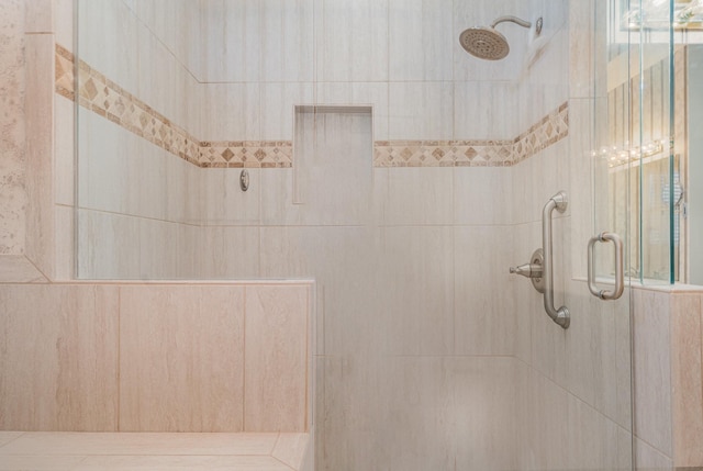 bathroom with a tile shower