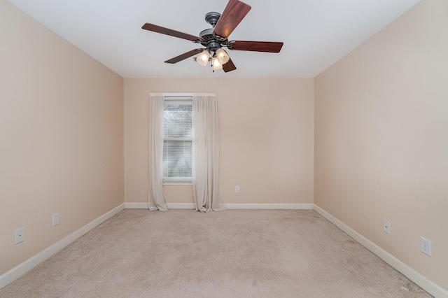 unfurnished room featuring baseboards, light colored carpet, and ceiling fan