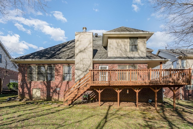 back of house featuring brick siding, a wooden deck, a lawn, and a chimney
