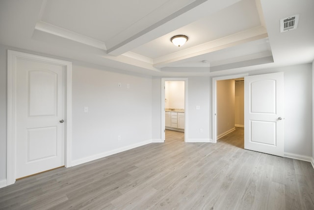 158 Oasis Dr, La Vergne, TN 37086 - unfurnished bedroom featuring visible vents, baseboards, a raised ceiling, and light wood-style floors