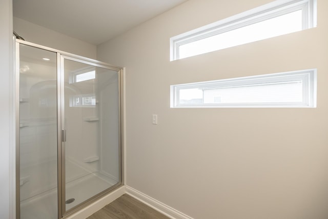 158 Oasis Dr, La Vergne, TN 37086 - bathroom featuring a stall shower, baseboards, and wood finished floors