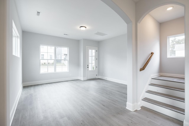 158 Oasis Dr, La Vergne, TN 37086 - foyer entrance with visible vents, wood finished floors, arched walkways, baseboards, and stairs