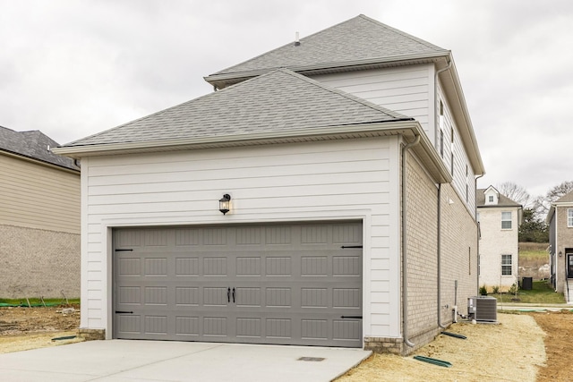 158 Oasis Dr, La Vergne, TN 37086 - garage featuring concrete driveway and central AC unit