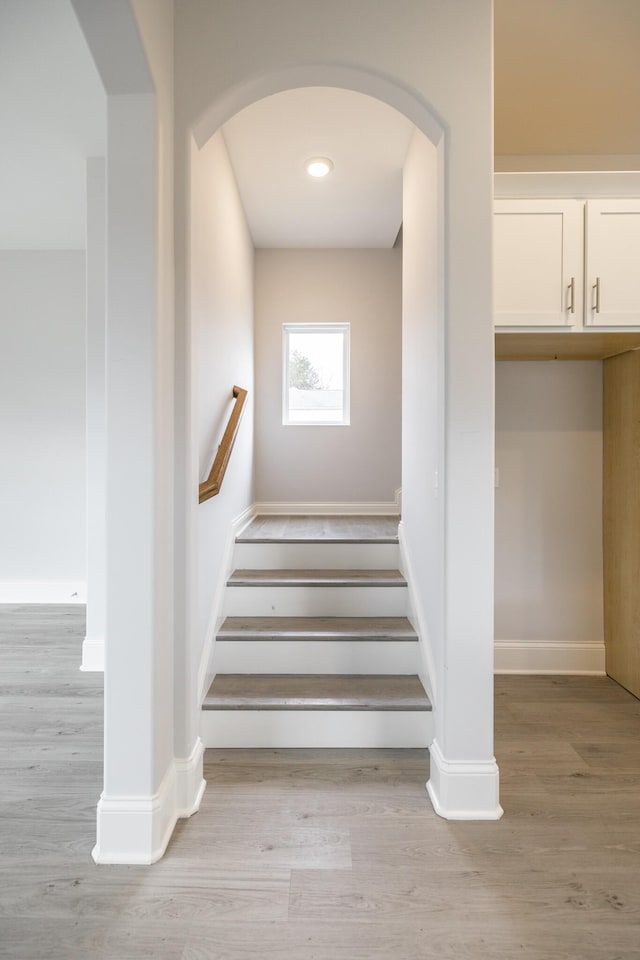 158 Oasis Dr, La Vergne, TN 37086 - stairs featuring baseboards, arched walkways, and wood finished floors