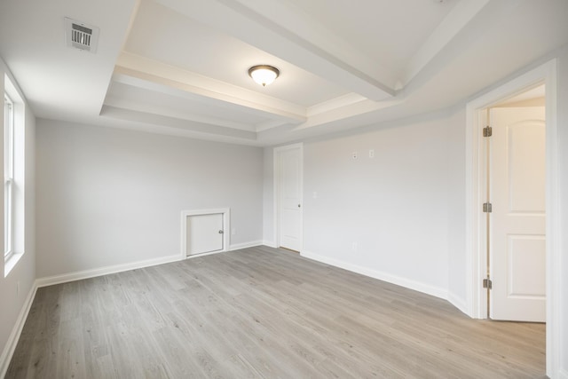 158 Oasis Dr, La Vergne, TN 37086 - spare room featuring visible vents, beamed ceiling, a raised ceiling, light wood-style flooring, and baseboards