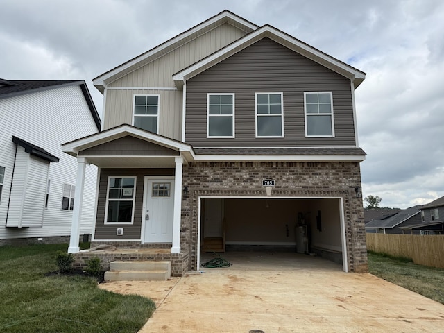 180 Cardinal Crk, Clarksville, TN 37040 - view of front facade featuring concrete driveway, a garage, water heater, and brick siding