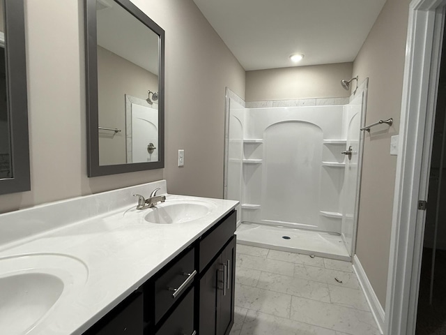 180 Cardinal Crk, Clarksville, TN 37040 - bathroom featuring marble look tiles, double vanity, a shower, and baseboards