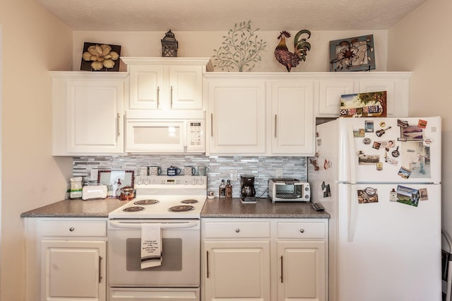 903 Churchill Xing, Madison, TN 37115 - kitchen featuring white appliances, white cabinets, dark countertops, and backsplash
