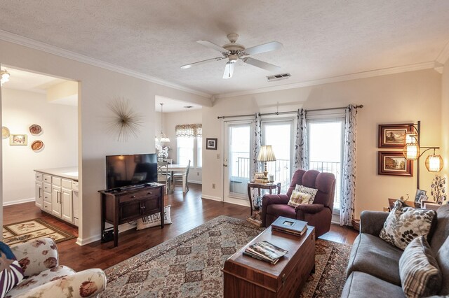 903 Churchill Xing, Madison, TN 37115 - living area featuring visible vents, ceiling fan with notable chandelier, a textured ceiling, crown molding, and dark wood-style flooring