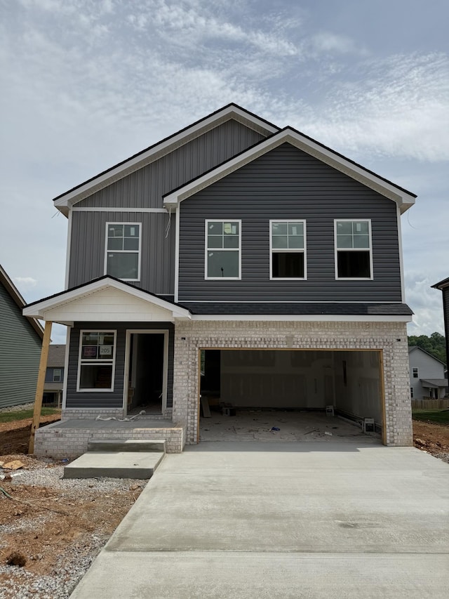 205 Cardinal Crk, Clarksville, TN 37040 - view of front facade featuring a garage, concrete driveway, a porch, and brick siding
