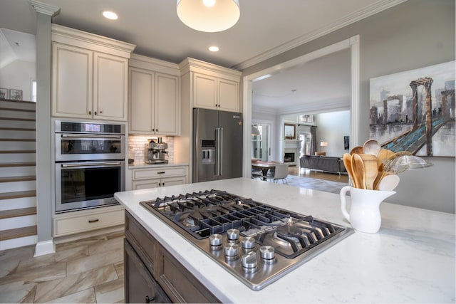 5217 Apple Mill Ct, Brentwood, TN 37027 - kitchen with stainless steel appliances, backsplash, recessed lighting, ornamental molding, and a fireplace