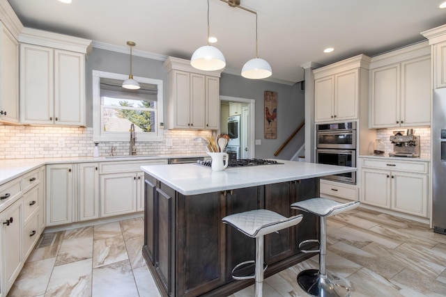 5217 Apple Mill Ct, Brentwood, TN 37027 - kitchen featuring stainless steel appliances, a sink, backsplash, a kitchen island, and ornamental molding