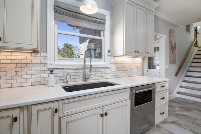 5217 Apple Mill Ct, Brentwood, TN 37027 - kitchen with stainless steel dishwasher, a sink, backsplash, light stone countertops, and ornamental molding