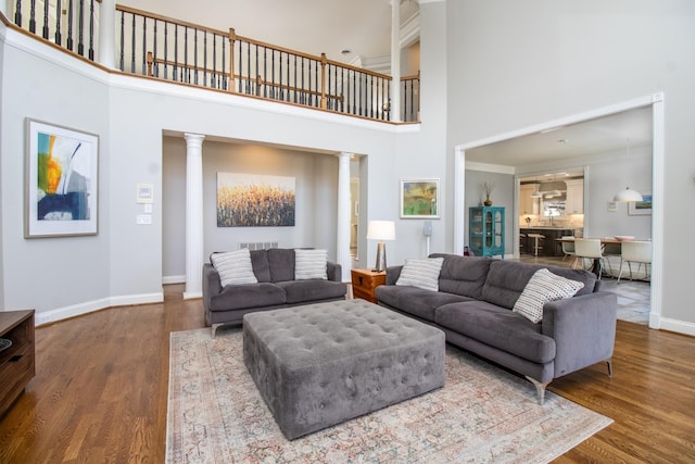 5217 Apple Mill Ct, Brentwood, TN 37027 - living area with a towering ceiling, baseboards, wood finished floors, decorative columns, and crown molding