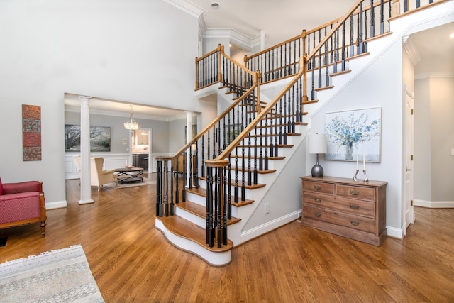 5217 Apple Mill Ct, Brentwood, TN 37027 - stairway featuring crown molding, a high ceiling, ornate columns, wood finished floors, and baseboards