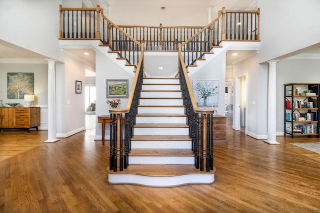 5217 Apple Mill Ct, Brentwood, TN 37027 - stairway with decorative columns, crown molding, a towering ceiling, wood finished floors, and baseboards