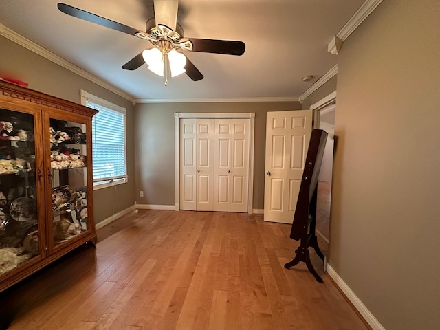 unfurnished bedroom featuring crown molding, baseboards, and light wood-type flooring