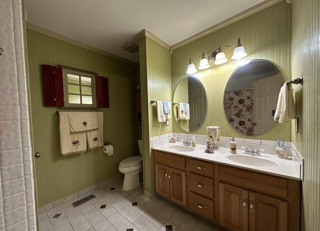 bathroom with toilet, ornamental molding, visible vents, and a sink