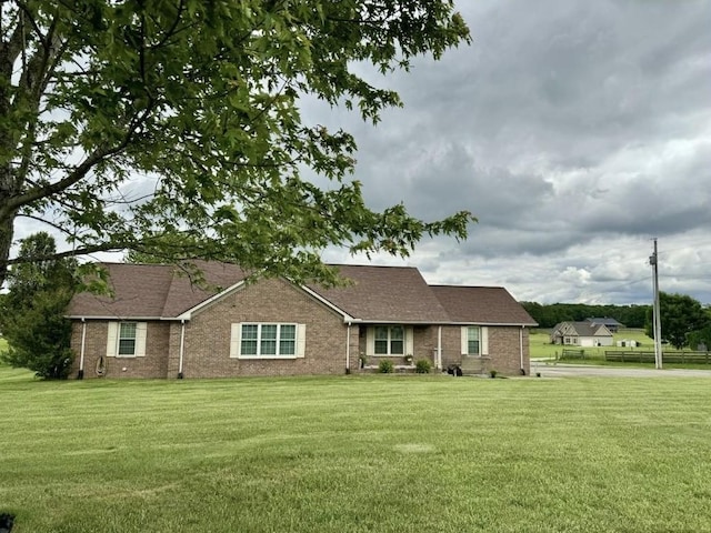 ranch-style home with brick siding and a front lawn