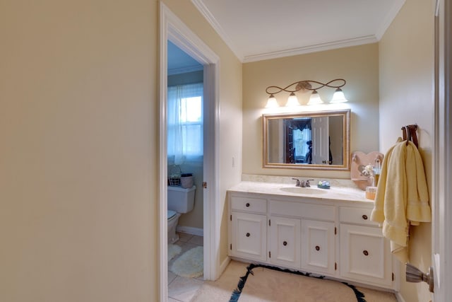 bathroom with vanity, baseboards, crown molding, toilet, and tile patterned floors