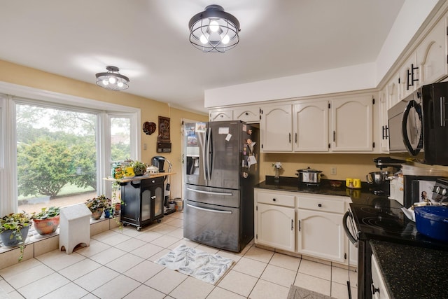 kitchen with black appliances and light tile patterned flooring
