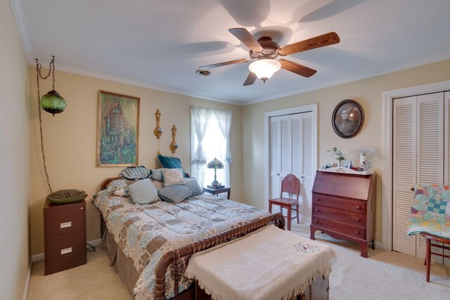 bedroom with baseboards, ceiling fan, multiple closets, crown molding, and light colored carpet