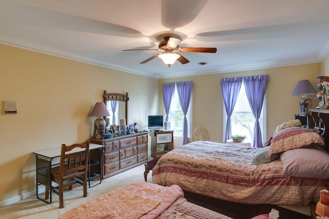 carpeted bedroom with crown molding, a ceiling fan, and baseboards