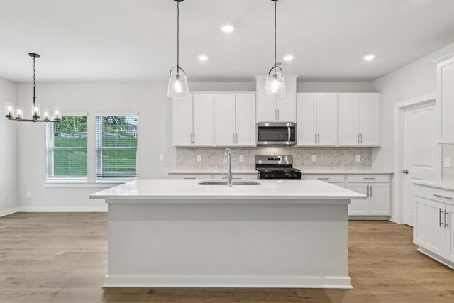 708 Brody Ct, Antioch, TN 37013 - kitchen featuring appliances with stainless steel finishes, backsplash, light countertops, white cabinets, and recessed lighting