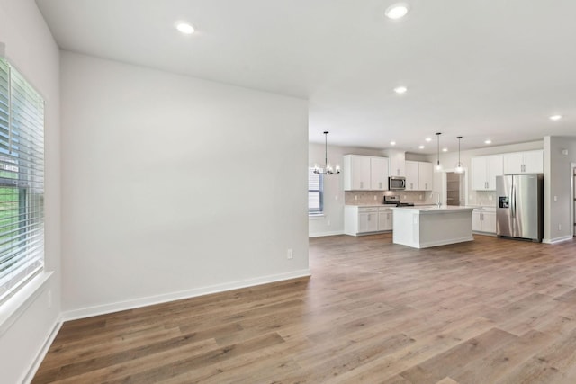 708 Brody Ct, Antioch, TN 37013 - unfurnished living room featuring a chandelier, light wood-style flooring, and recessed lighting