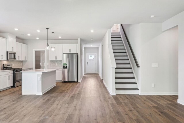 708 Brody Ct, Antioch, TN 37013 - kitchen with appliances with stainless steel finishes, decorative backsplash, light countertops, white cabinets, and recessed lighting