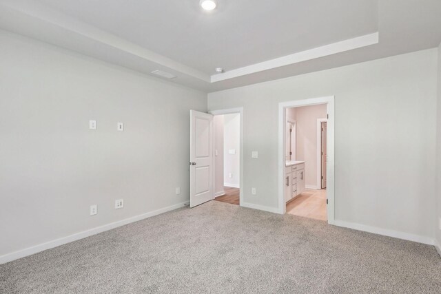 708 Brody Ct, Antioch, TN 37013 - unfurnished bedroom with light colored carpet, a tray ceiling, and ensuite bath