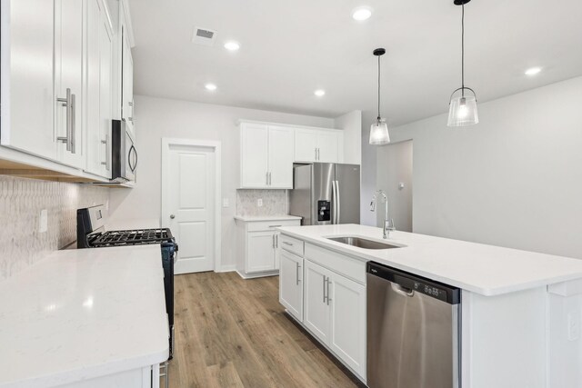 708 Brody Ct, Antioch, TN 37013 - kitchen with stainless steel appliances, decorative backsplash, light countertops, a kitchen island with sink, and recessed lighting