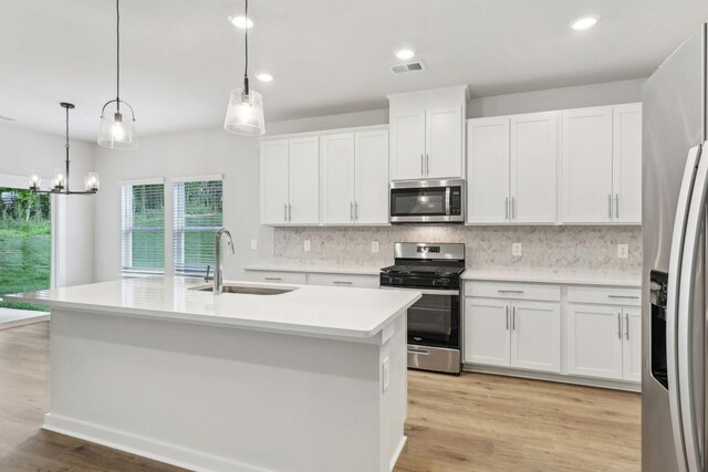 708 Brody Ct, Antioch, TN 37013 - kitchen featuring stainless steel appliances, decorative backsplash, light countertops, white cabinetry, and recessed lighting