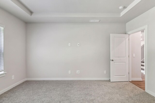 708 Brody Ct, Antioch, TN 37013 - carpeted spare room featuring a tray ceiling, a smoke detector, and stairway