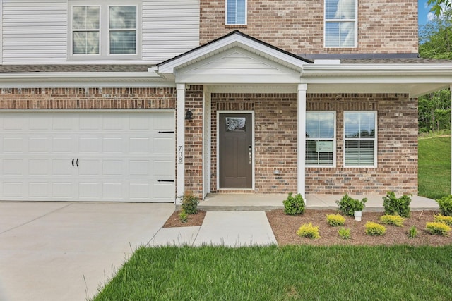 708 Brody Ct, Antioch, TN 37013 - entrance to property featuring brick siding, concrete driveway, an attached garage, and a porch