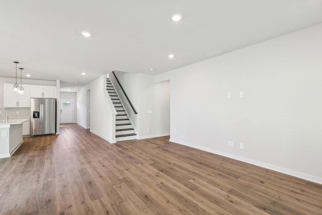 708 Brody Ct, Antioch, TN 37013 - unfurnished living room featuring recessed lighting, stairway, and light wood-style flooring