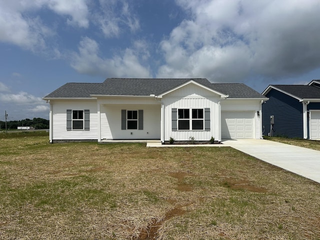 32 Ruth Dr, Elkton, KY 42220 - view of front of property featuring board and batten siding, an attached garage, driveway, and a front yard