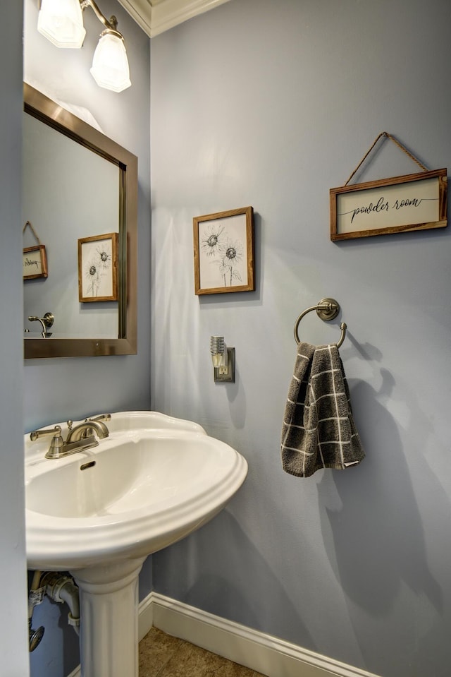 bathroom with baseboards and a sink