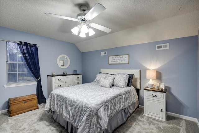 bedroom featuring carpet, baseboards, visible vents, vaulted ceiling, and a textured ceiling