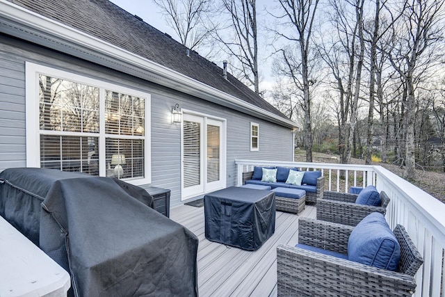 wooden terrace featuring an outdoor living space and area for grilling