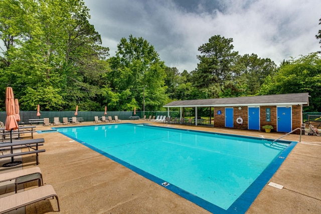 pool featuring a patio and fence