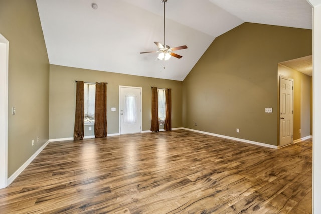 unfurnished living room with a healthy amount of sunlight, baseboards, wood finished floors, and a ceiling fan