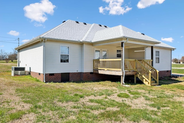 back of property featuring covered porch, crawl space, central air condition unit, and a yard